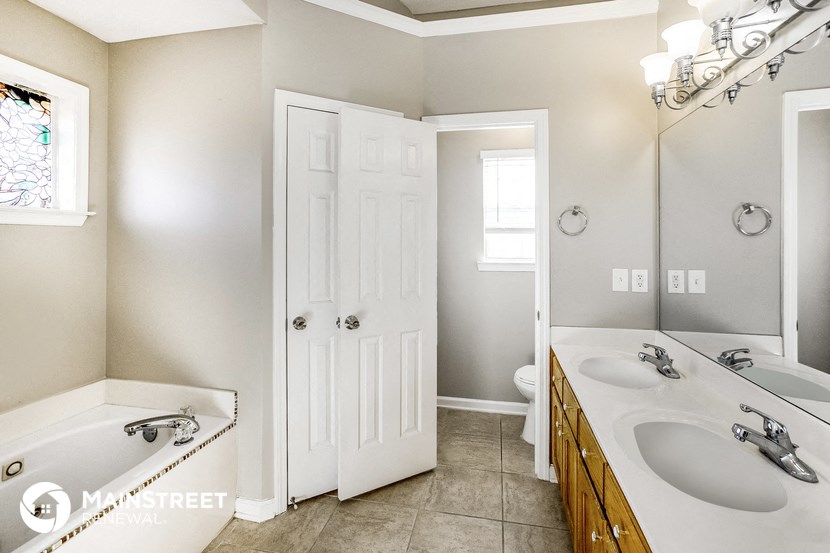 a bathroom with two sinks and a tub and a shower