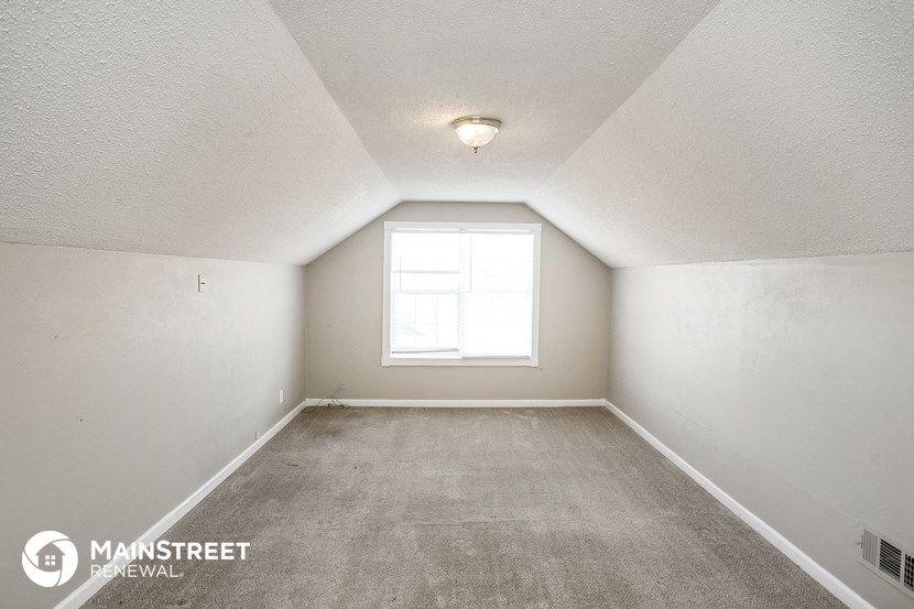 the living room of an empty house with a window