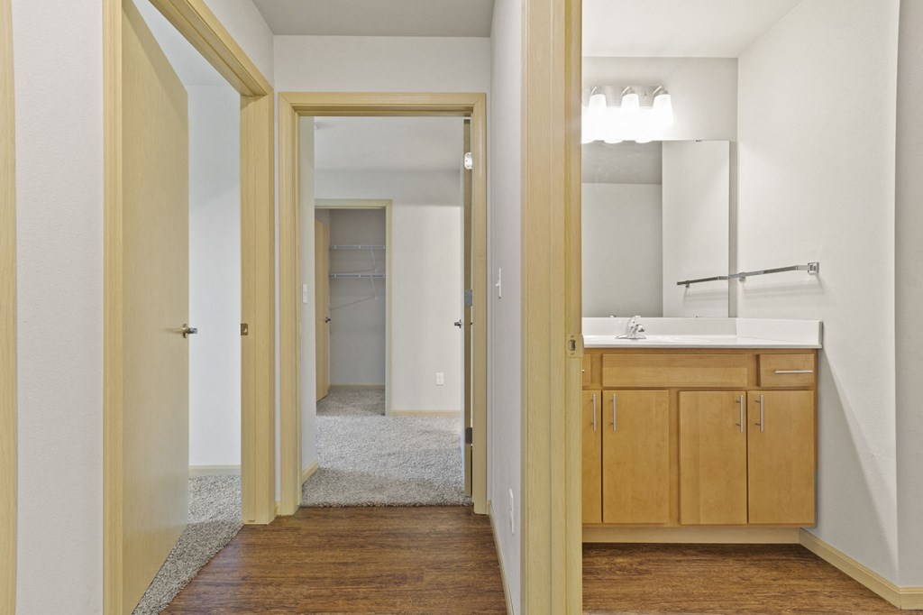 an empty bathroom with a sink and a mirror