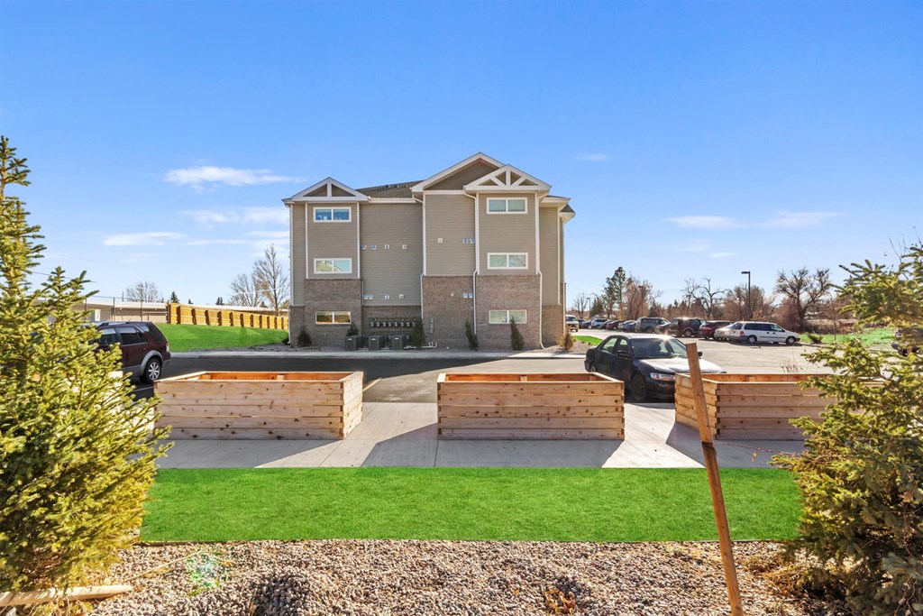 the front yard of a house with wooden planters