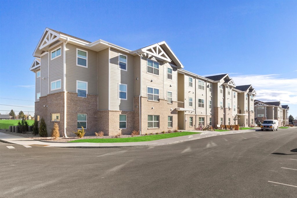 an apartment building with a street in front of it