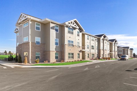 an apartment building with a street in front of it