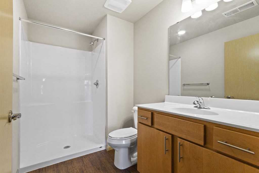a bathroom with a shower sink and toilet
