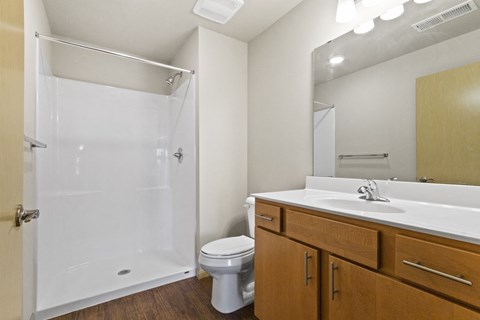 a bathroom with a shower sink and toilet