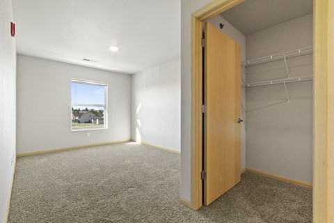 a empty room with a closet and a window