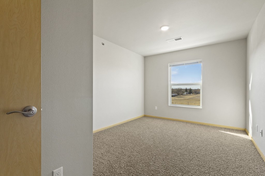 a empty room with a window and a door