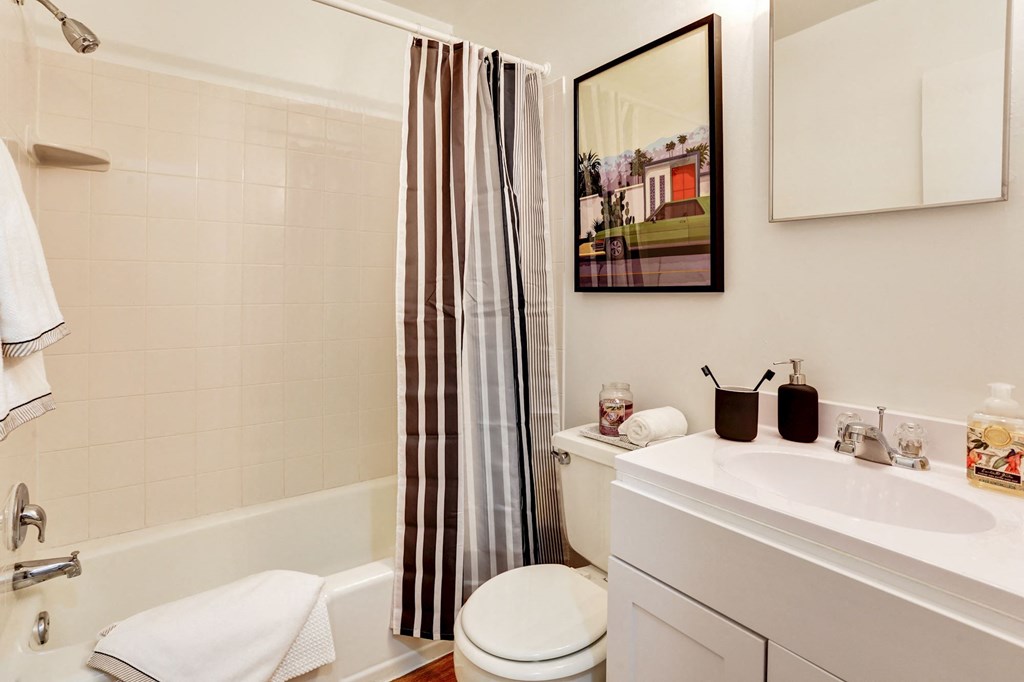 a bathroom with a sink toilet and a shower