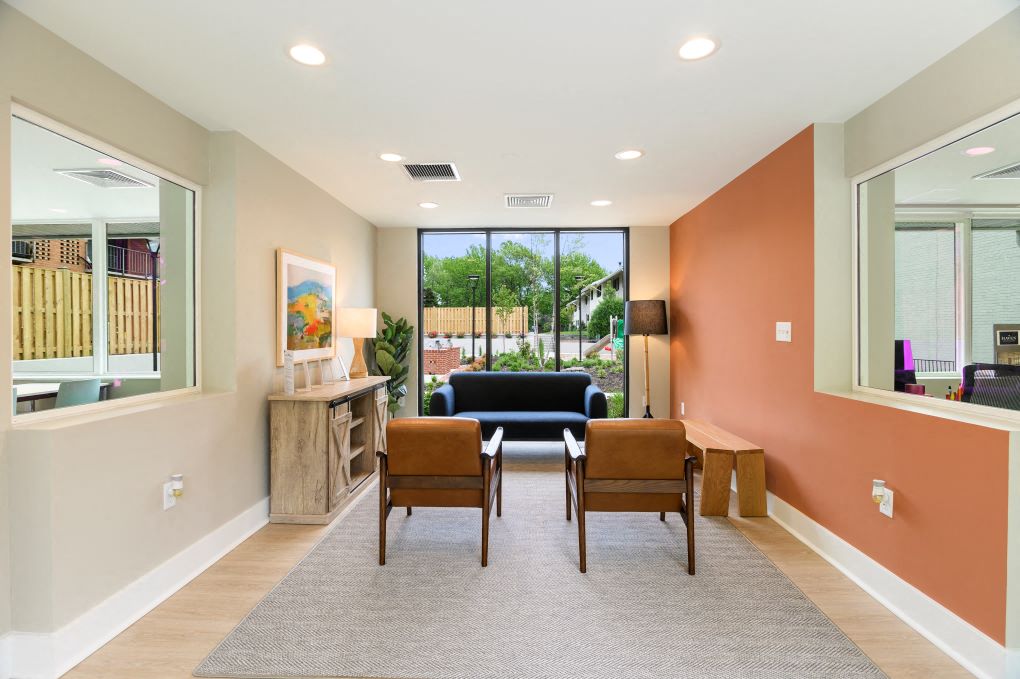 a living room with a couch and chairs and a table