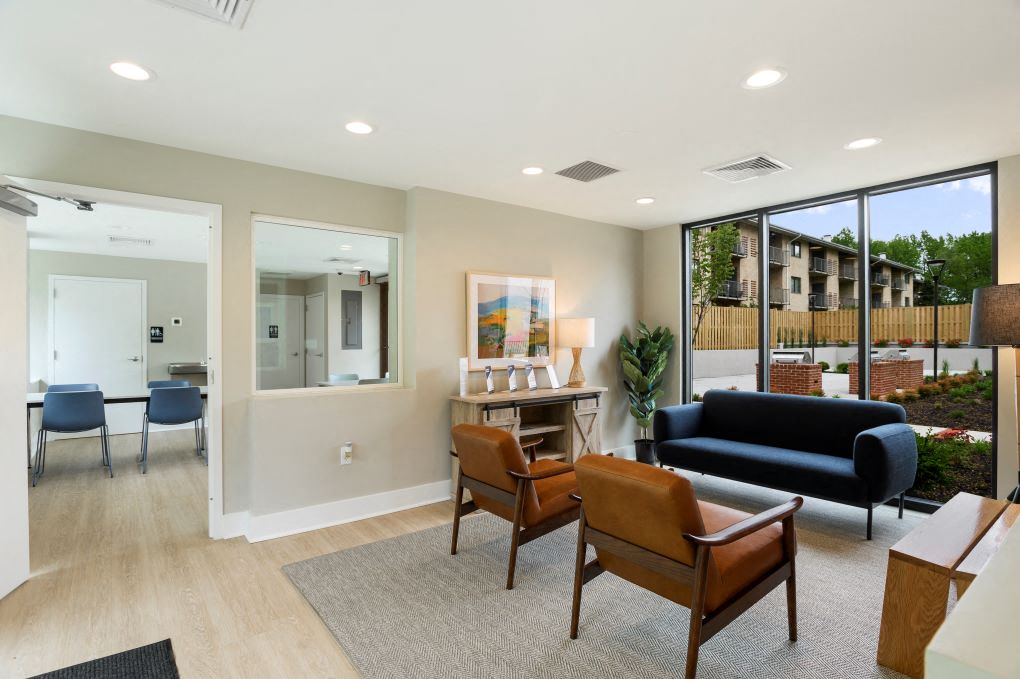 a living room with a couch and chairs