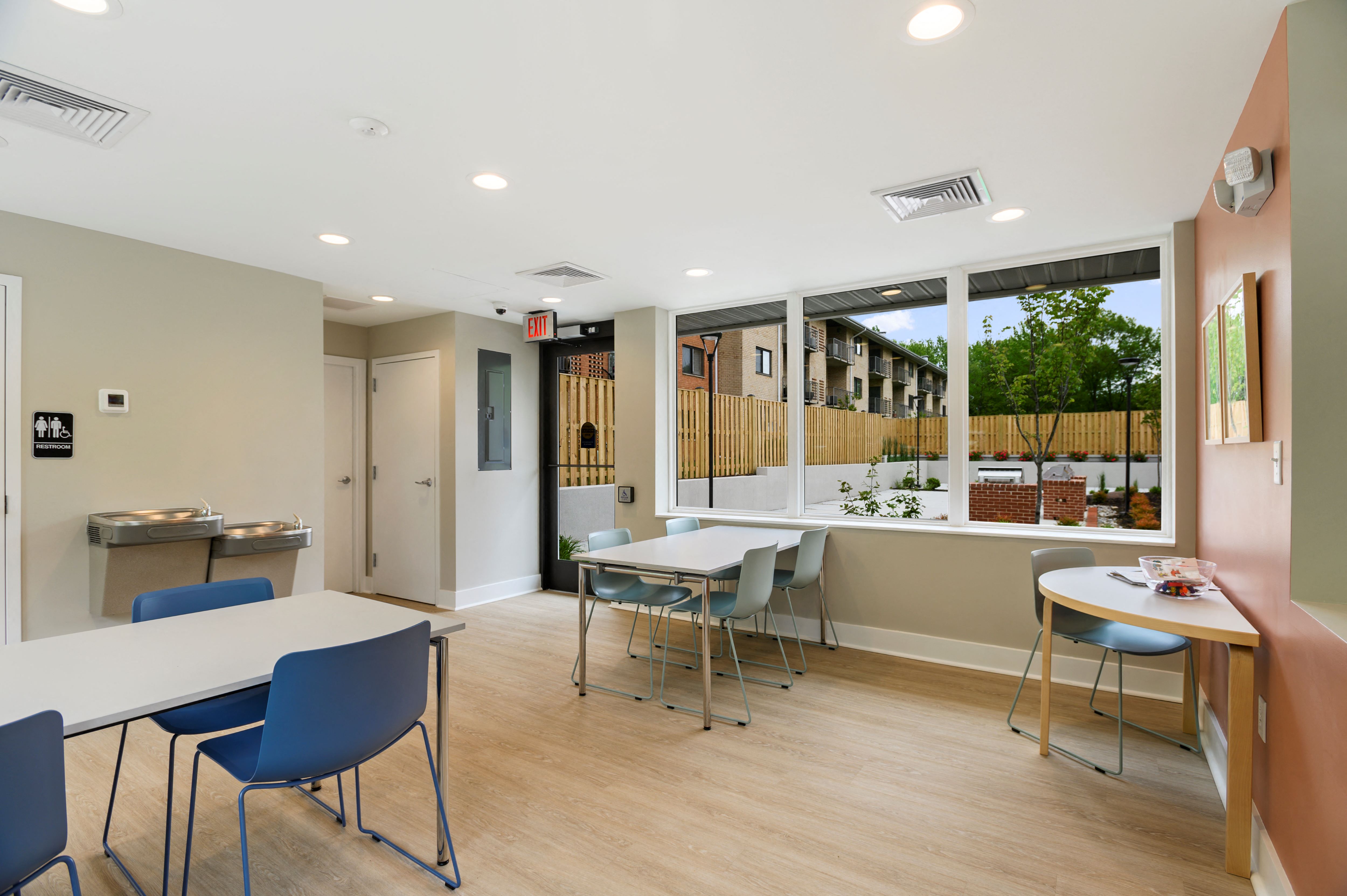 a dining room with tables and chairs and a window