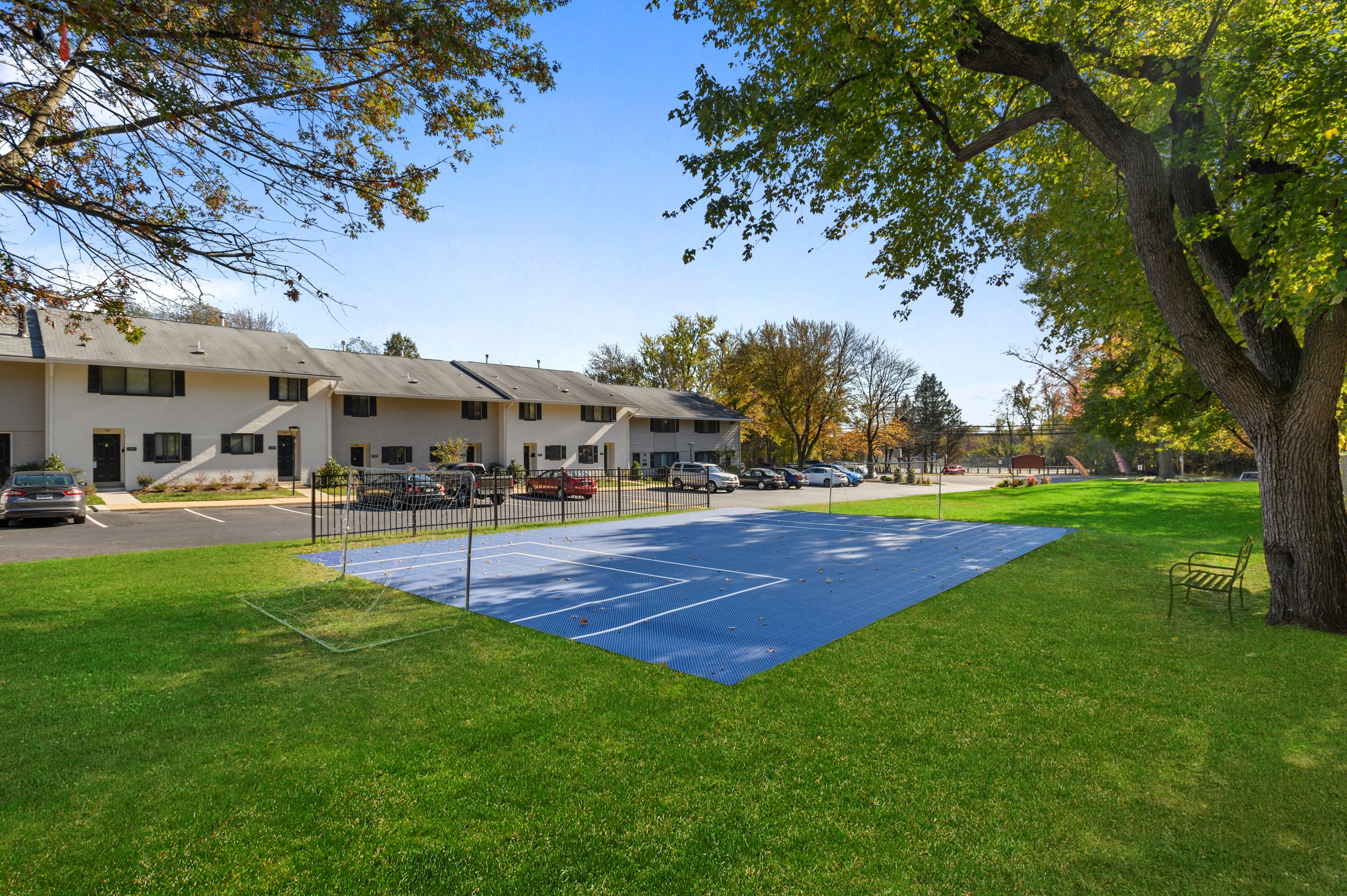 a blue basketball court in front of a building