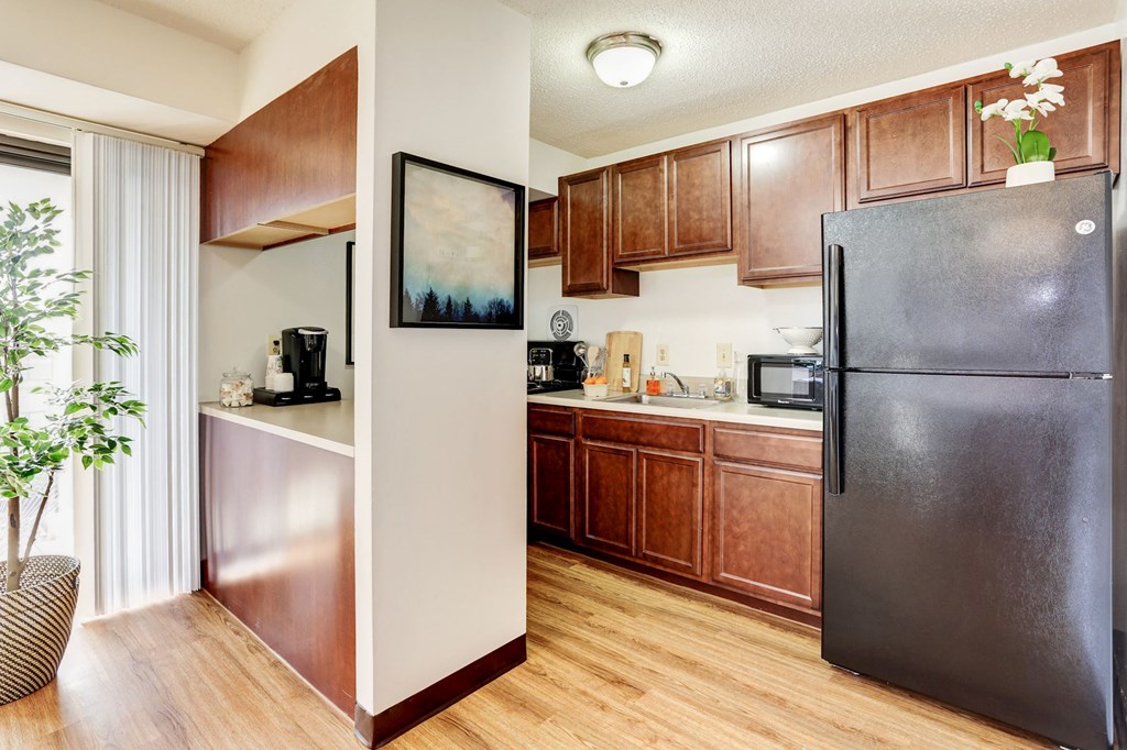 a kitchen with stainless steel appliances and wooden cabinets