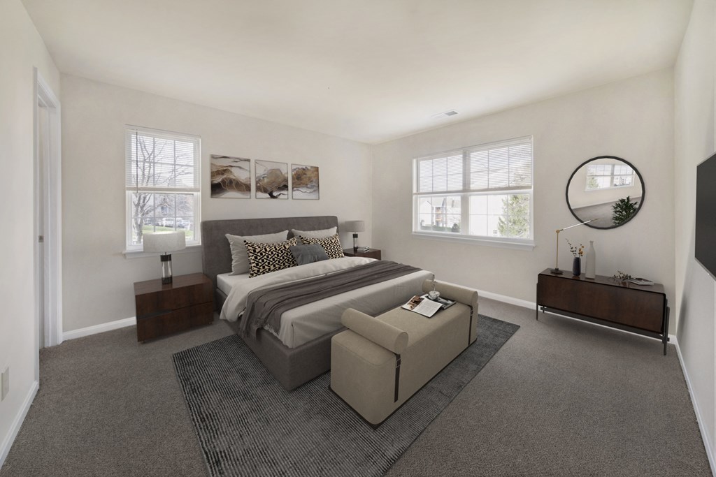 the master bedroom has a large bed and a large window