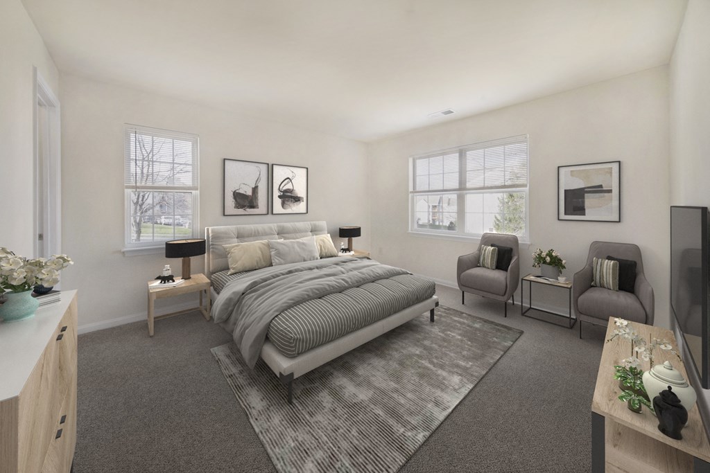 a bedroom with a bed and two chairs and a rug