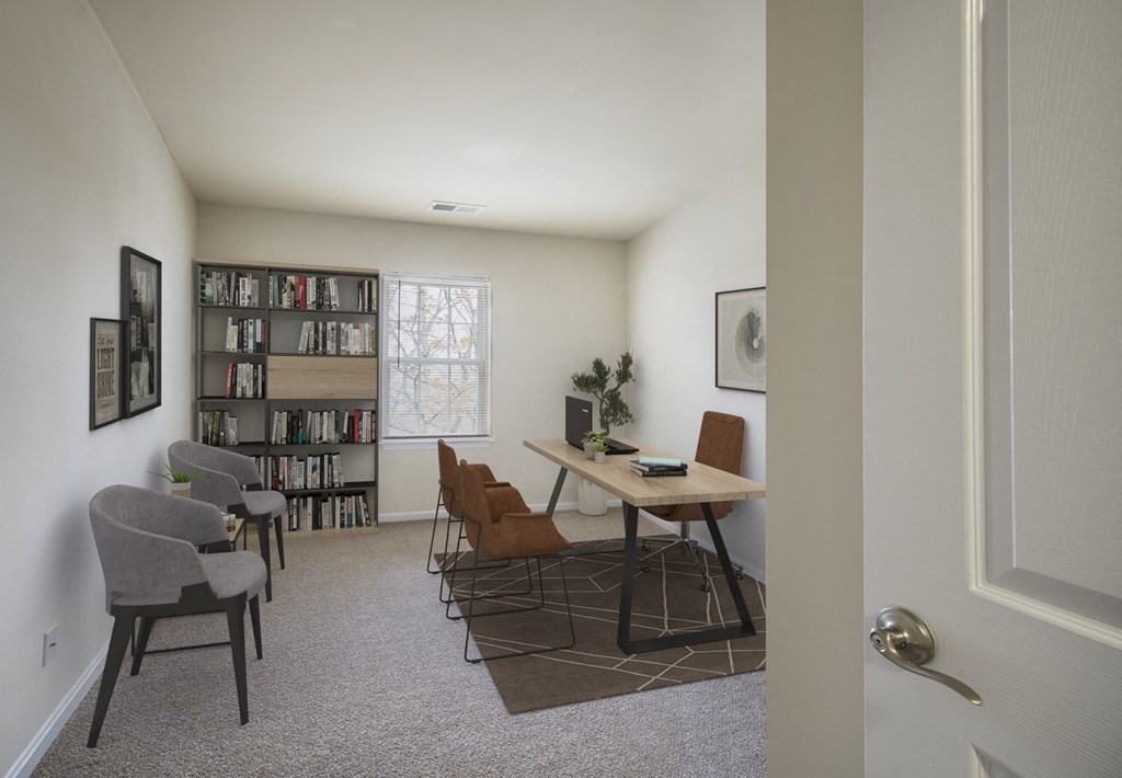 the living room of an apartment with a table and chairs