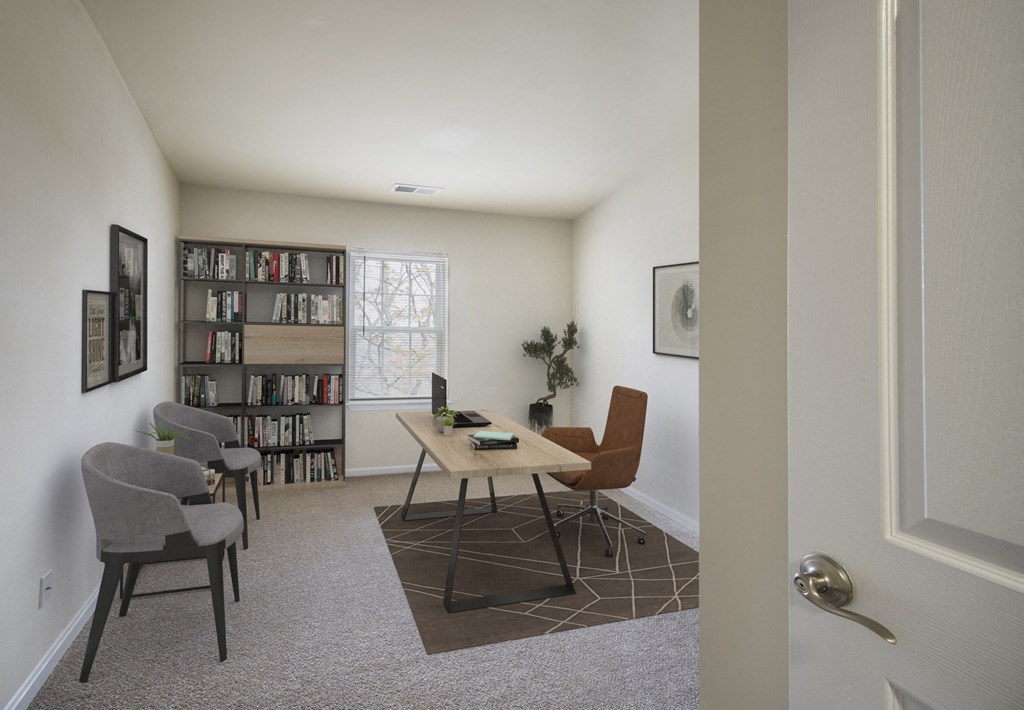 a living room with a table and chairs and a book shelf