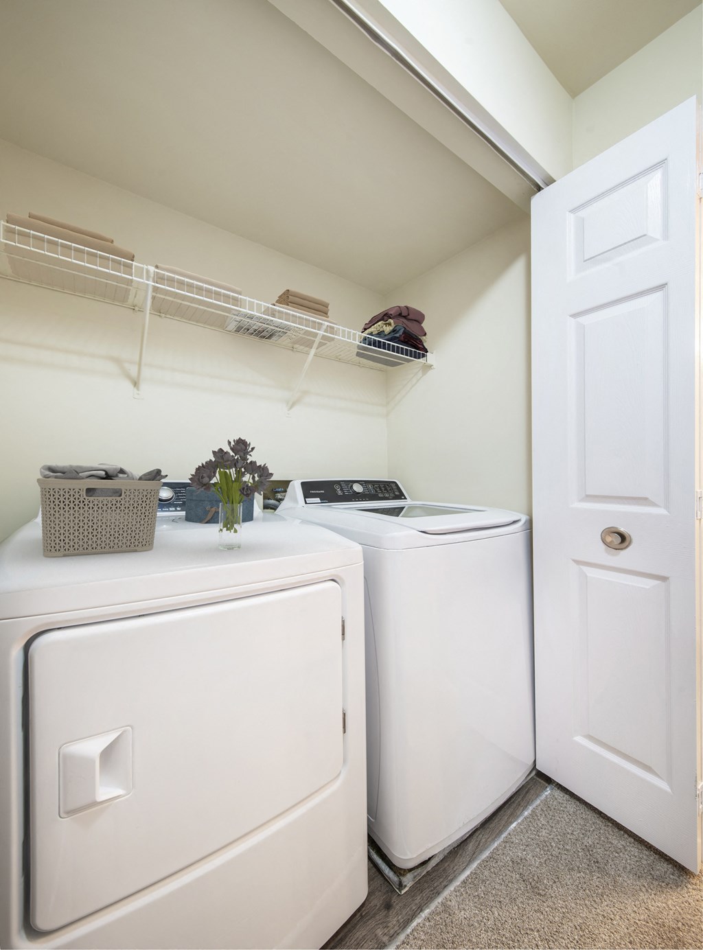 a washer and dryer in a laundry room with a white door