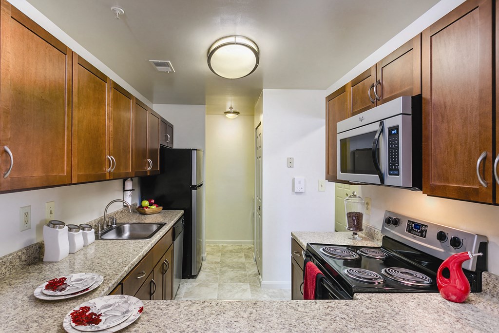 full kitchen with granite counter tops and stainless steel appliances