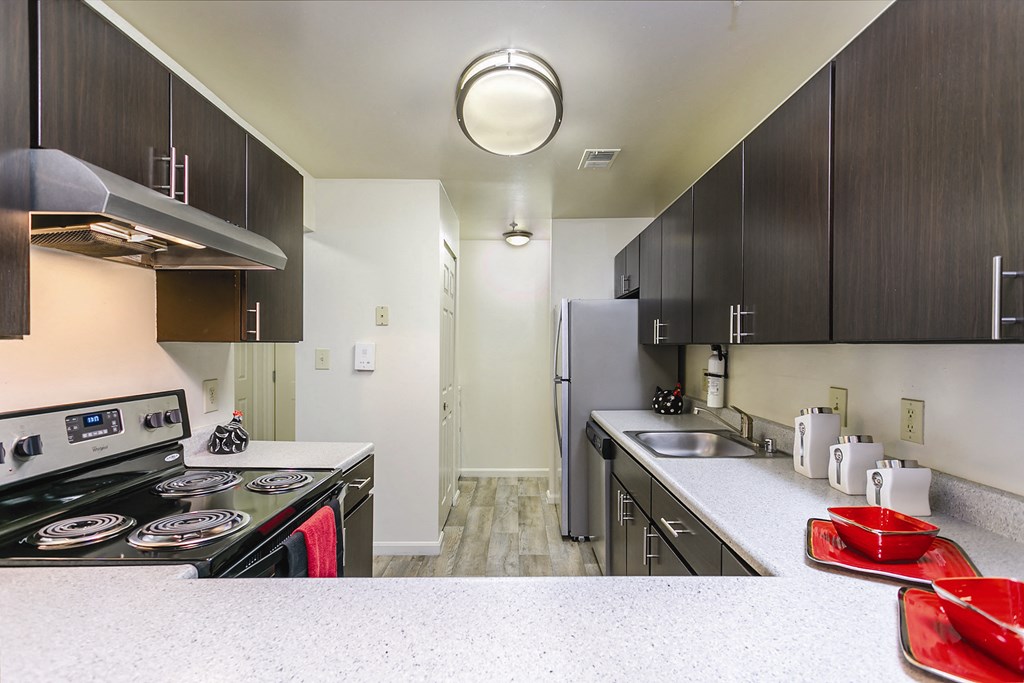 a kitchen with stainless steel appliances and white counter tops