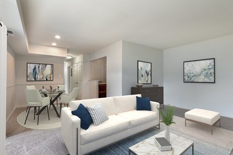 A living room with a white couch and a coffee table.