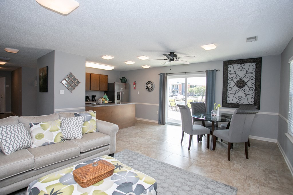 a living room and dining room with a couch and a table