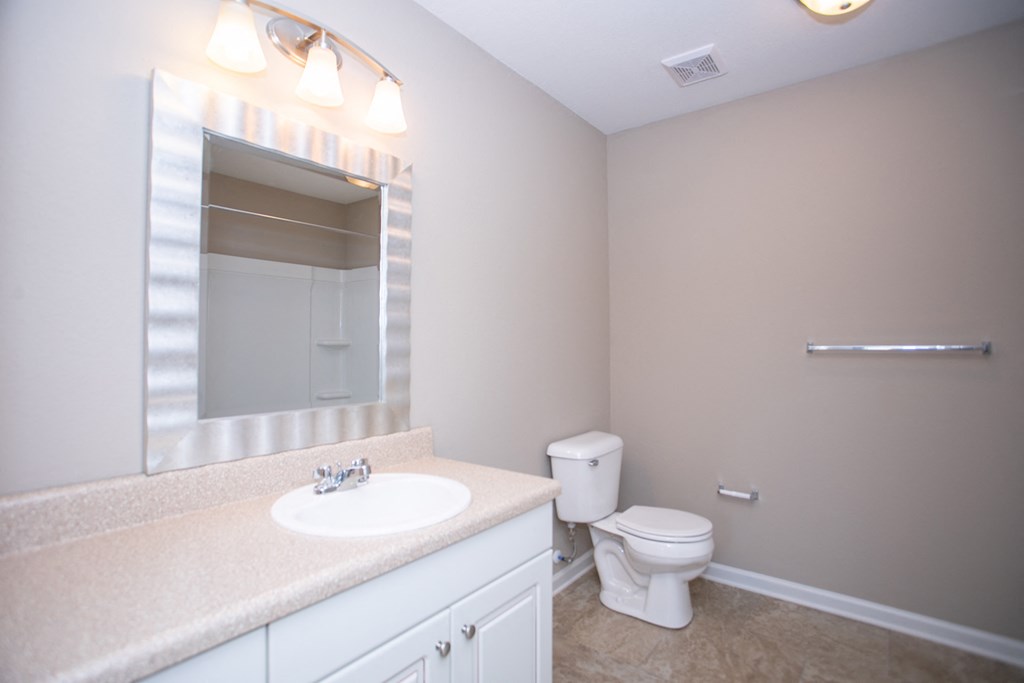 a bathroom with a toilet and a sink and a mirror