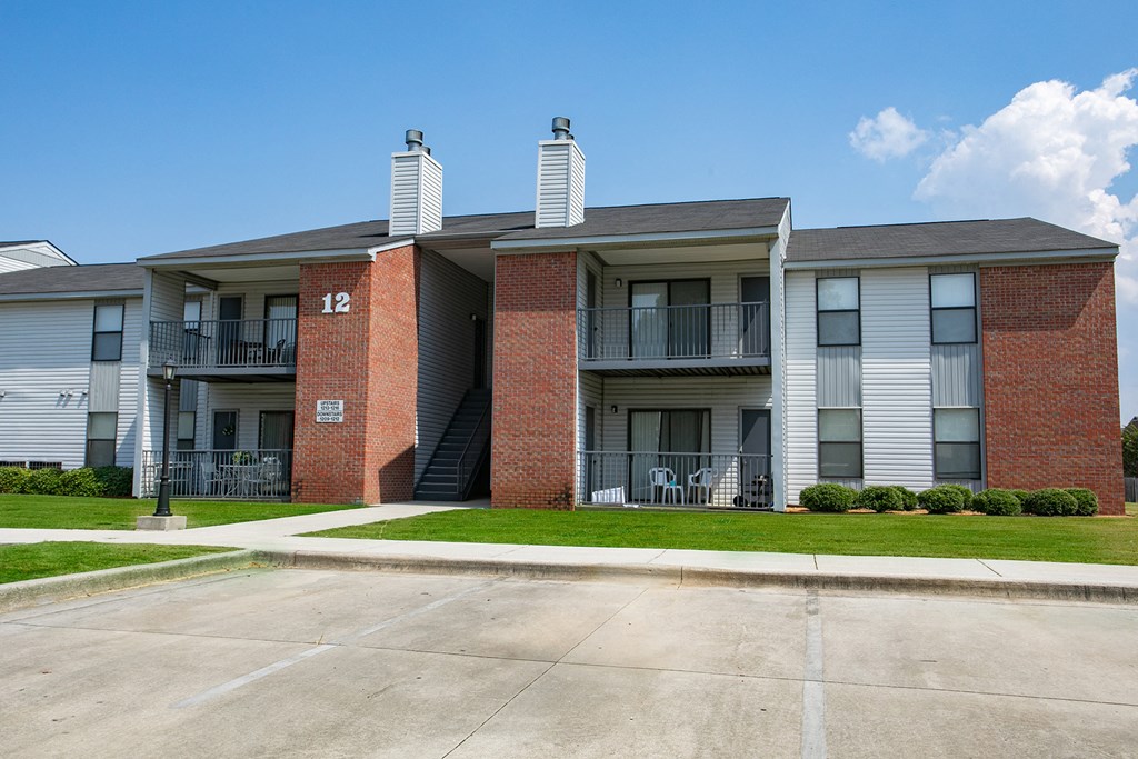 an apartment building with red brick and white columns