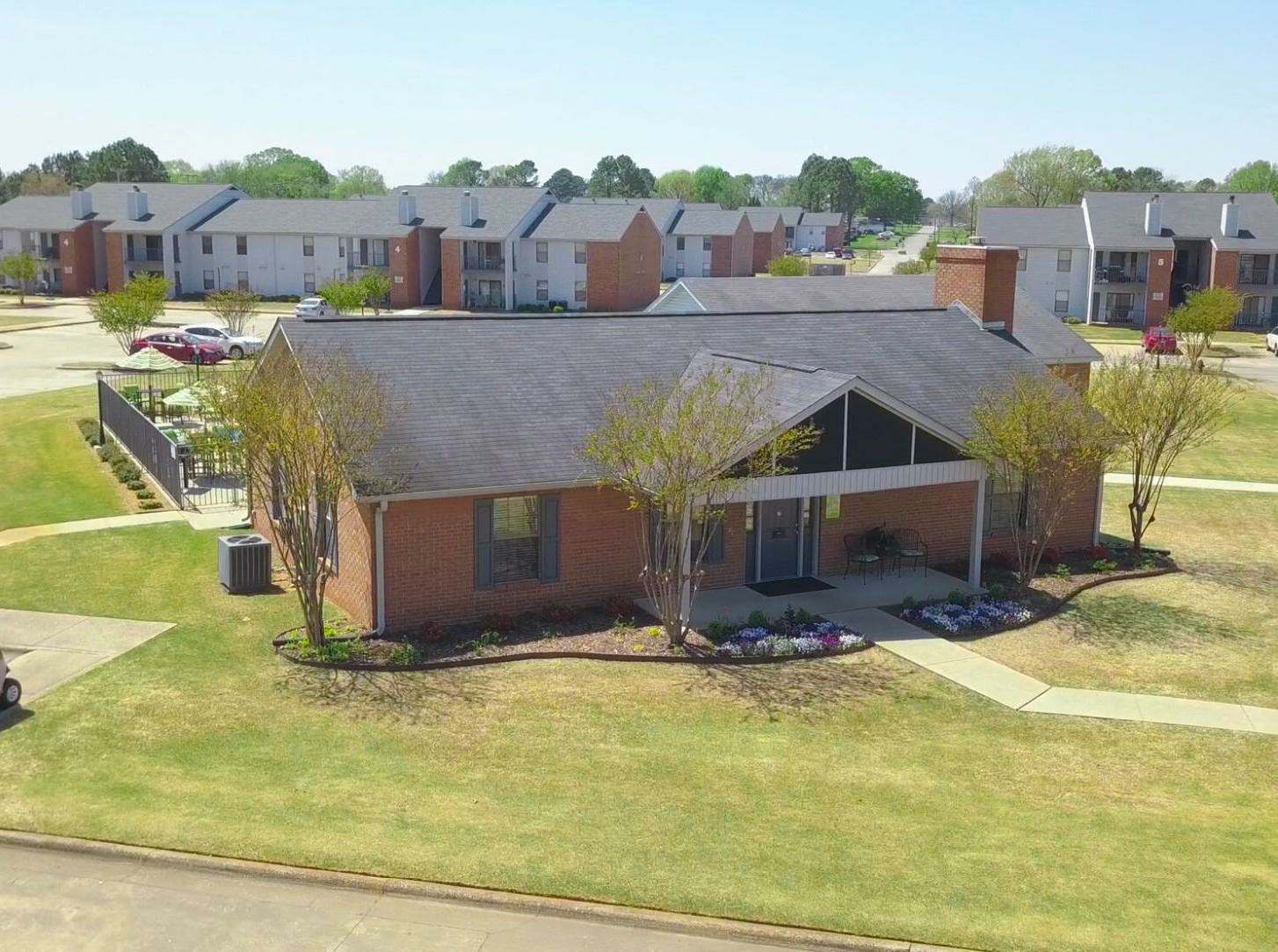 an aerial view of a house in a neighborhood with trees