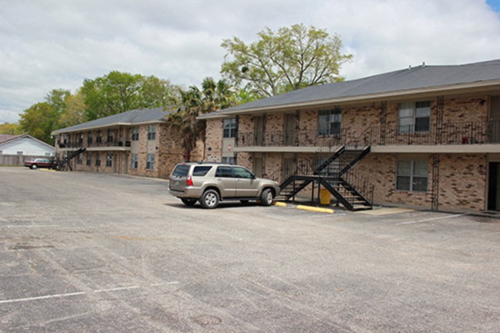 a parking lot with a car in front of a building