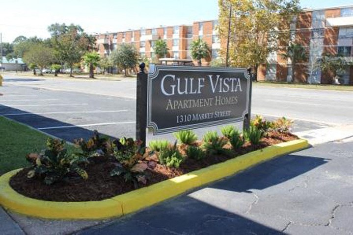 a sign in a parking lot in front of a building