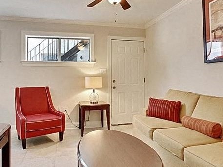 a living room with a couch and a chair and a table