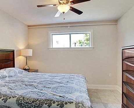 a bedroom with a bed and a ceiling fan
