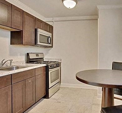 a kitchen with a stove microwave and a table