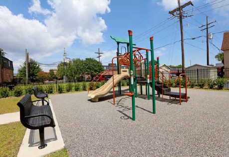 a playground with a swing set and a bench