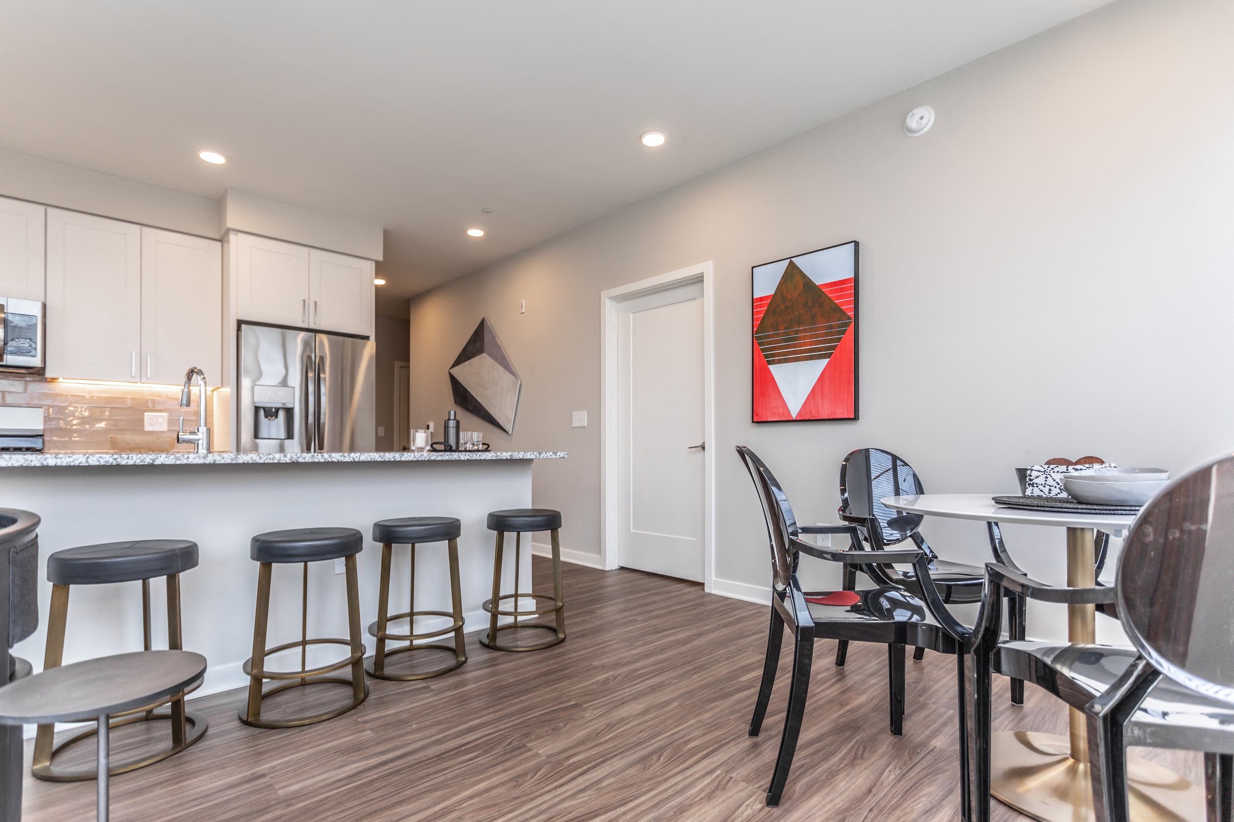 Open layout in Main Line apartment with dining area and modern kitchen with breakfast bar