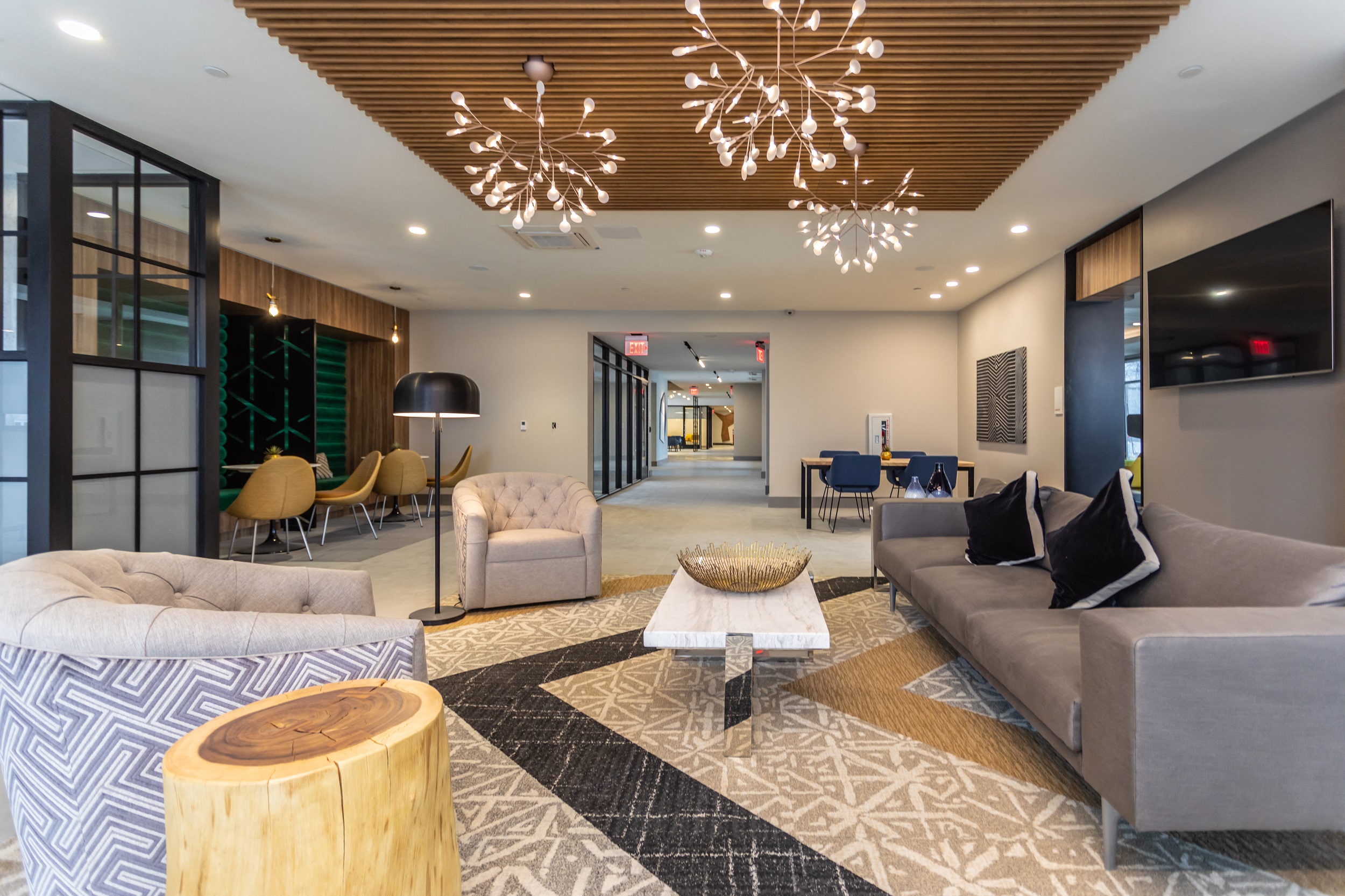 Community room with plenty of seating and contemporary lighting fixtures