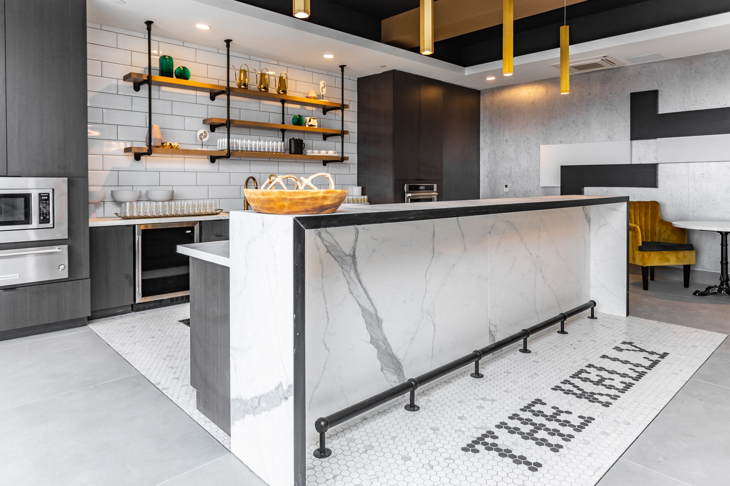 Gourmet demonstration kitchen with bar and contemporary lighting