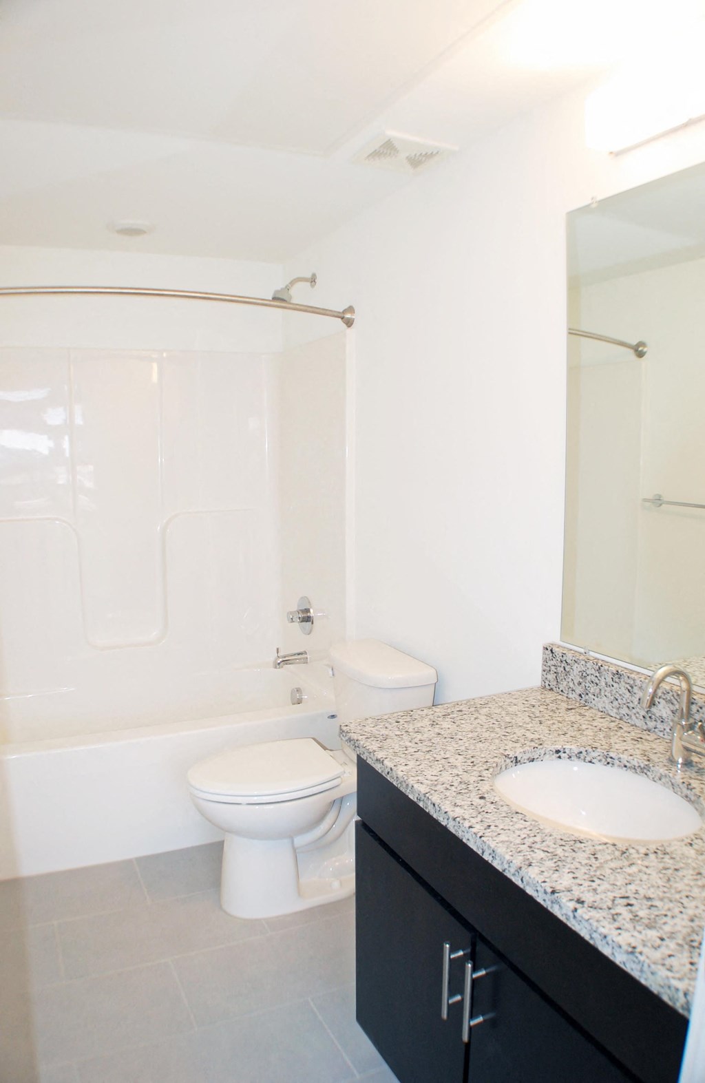 a white bathroom with a sink toilet and shower