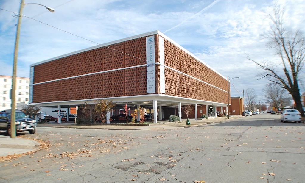 a brick building with a store on the corner of a street