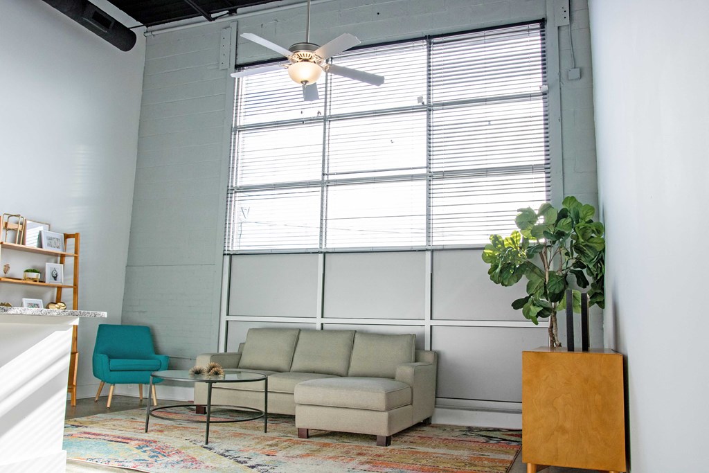 a living room with a couch and a ceiling fan
