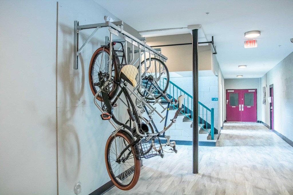 a bike hanging on a wall in a lobby