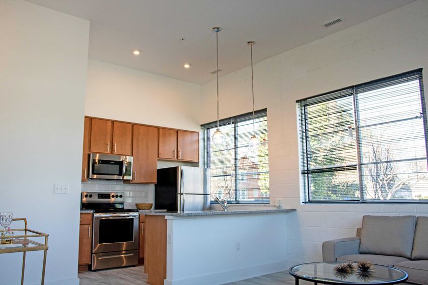 an open kitchen and living room with a couch and a table