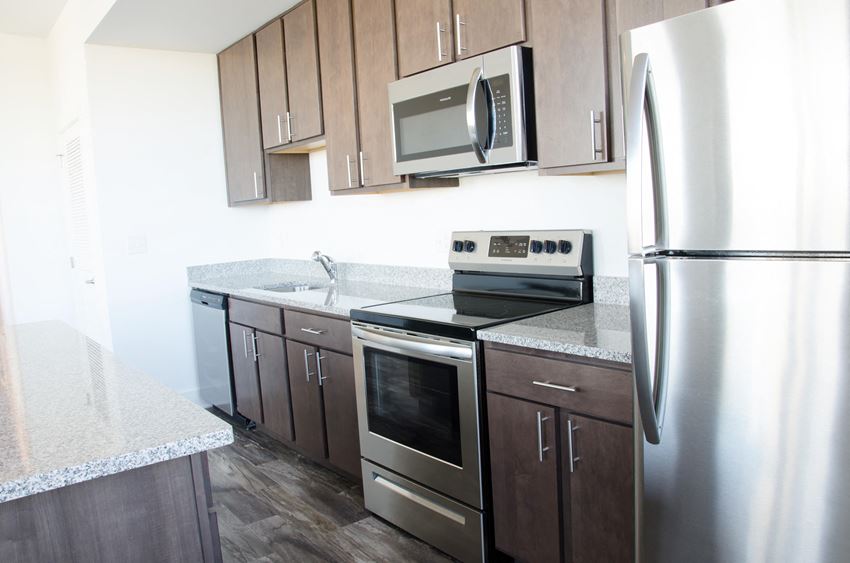 a kitchen with stainless steel appliances and wooden cabinets