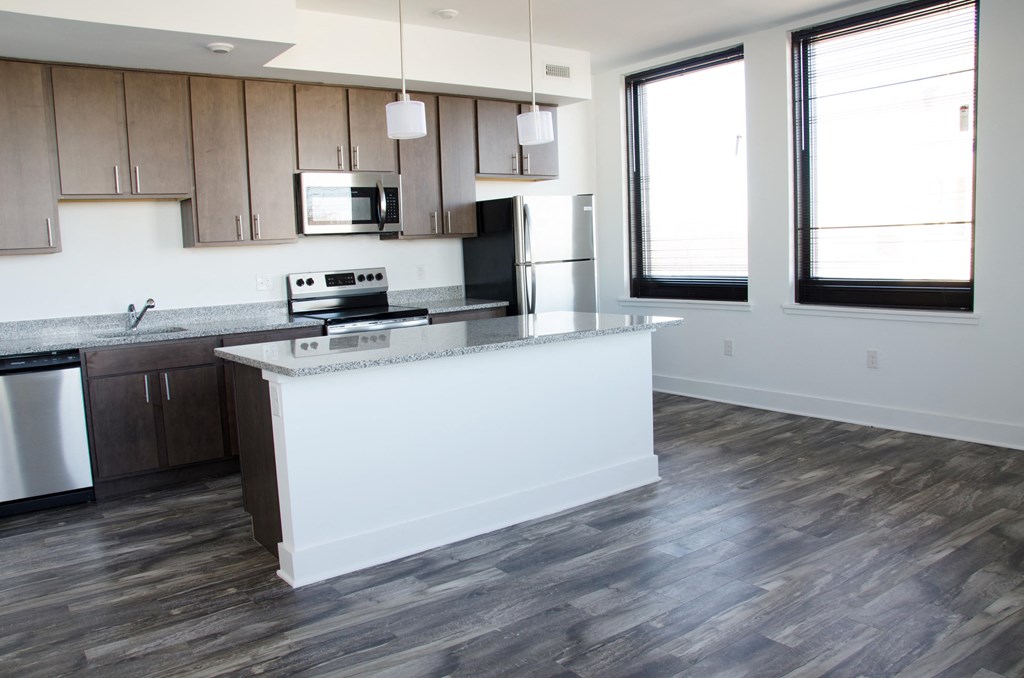 an empty kitchen with a large island in the middle