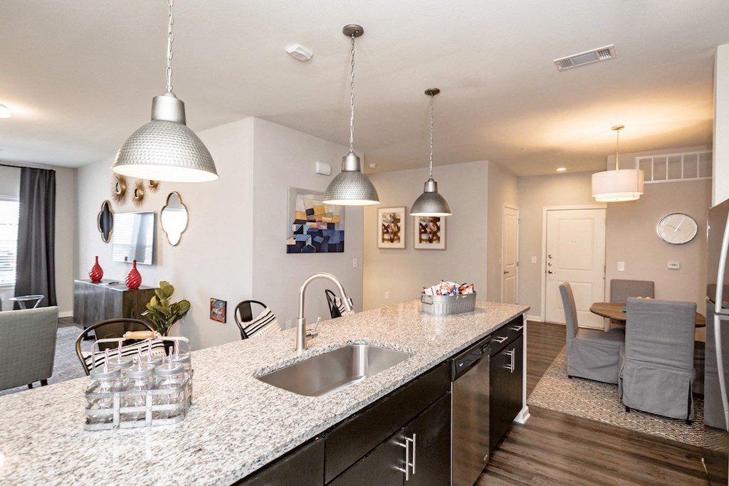view of living room from kitchen with granite counter top and stainless steel appliances