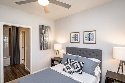a bedroom with a bed and a ceiling fan