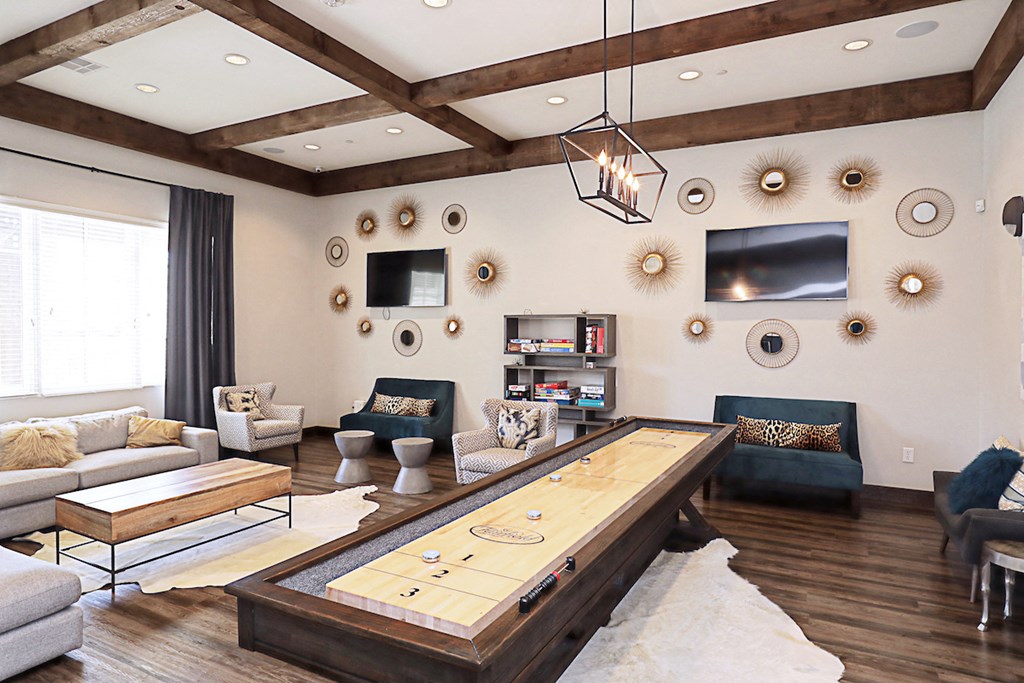 a living room with a large wooden table in the middle