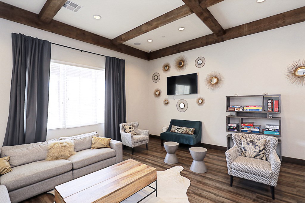 a living room with couches and chairs and a tv