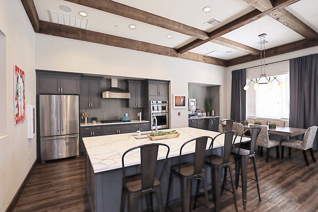 a kitchen with a large island and a table with chairs