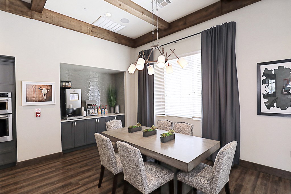a dining room with a table and chairs and a kitchen